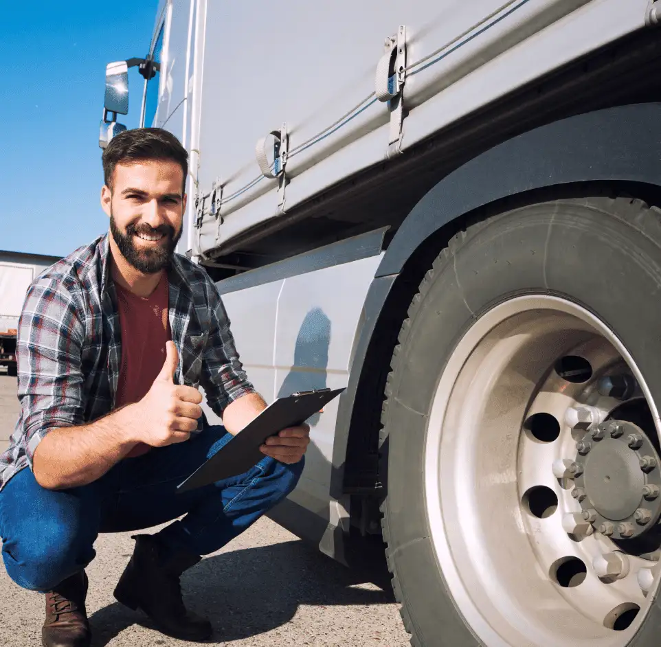 Truck Driver Standing Next to Vehicle